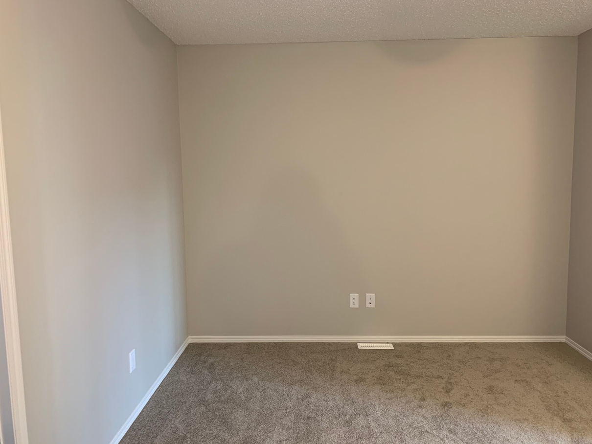 an empty room with carpet and gray walls Bonus room in a new build home in Edmonton Alberta