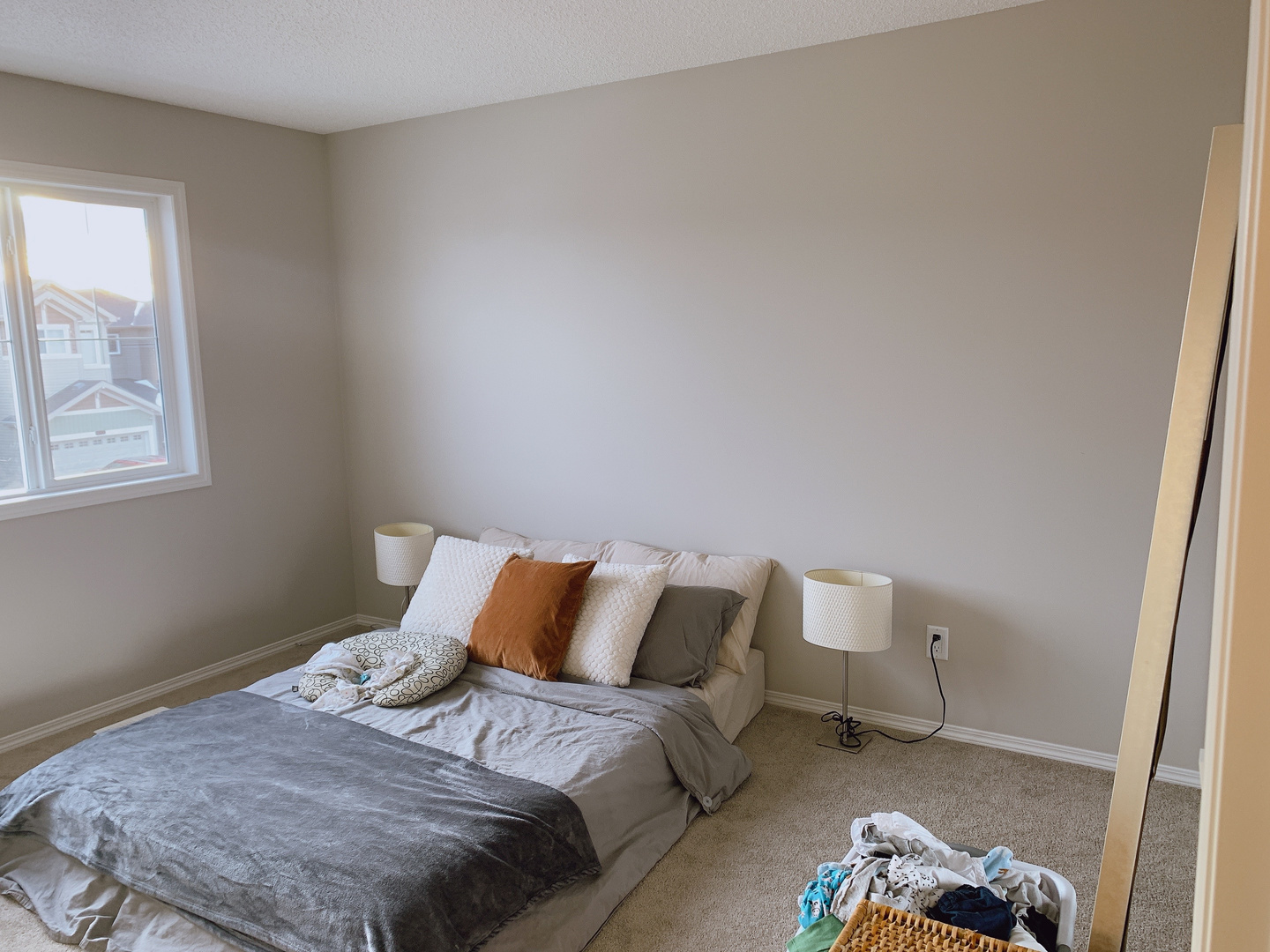 a bedroom with a bed and a window by Sterling Home in Edmonton Alberta